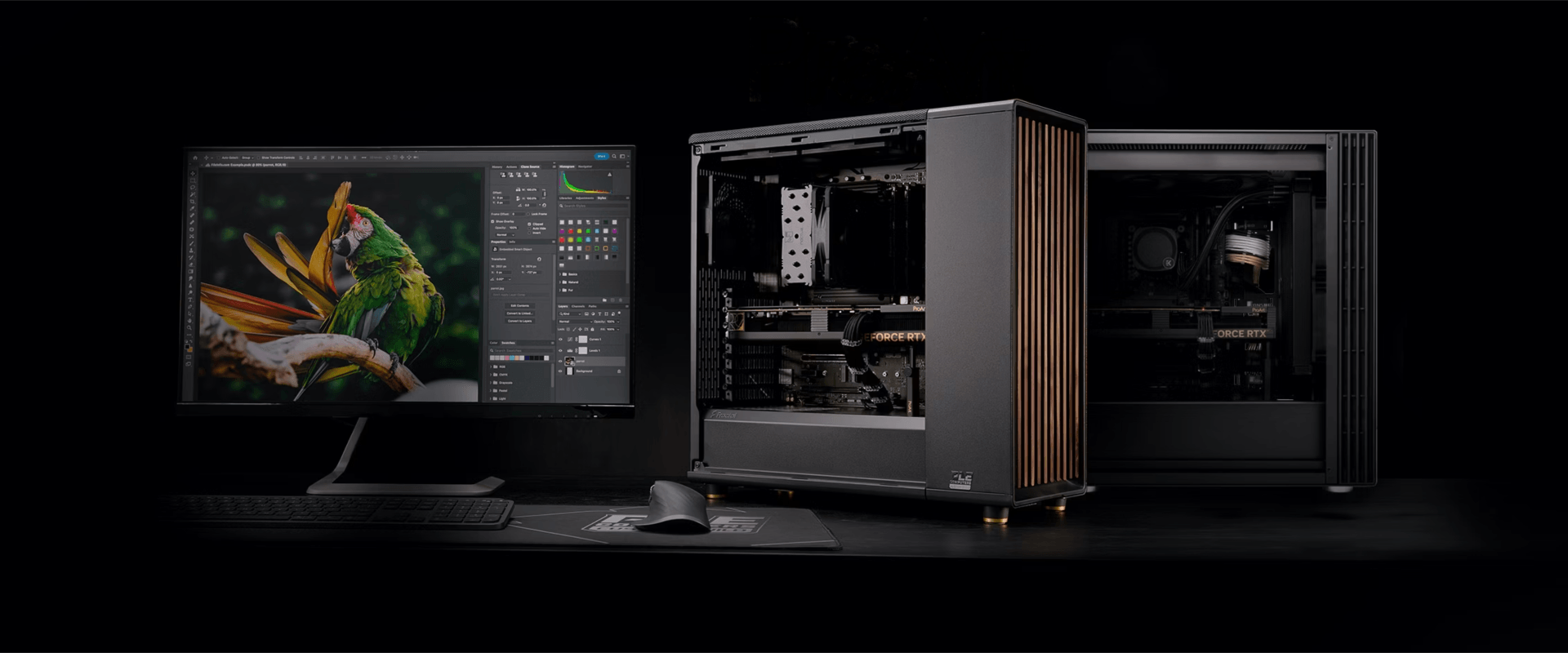 Стильный настольный ПК с минималистичным корпусом и монитор с изображением попугая, символизирующий работу с графикой.